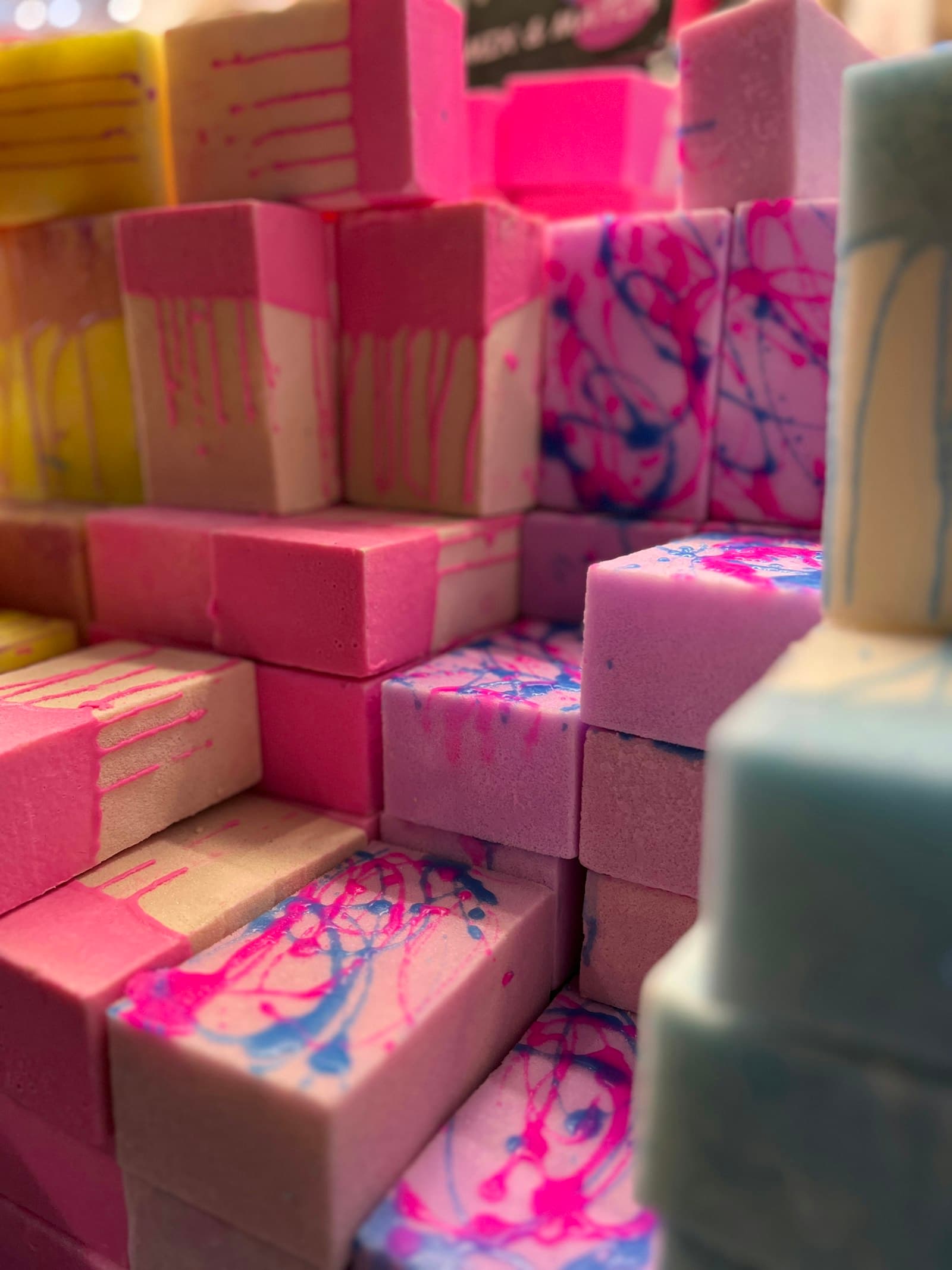 Stacked cubes of pink, lavender, and yellow handmade soap